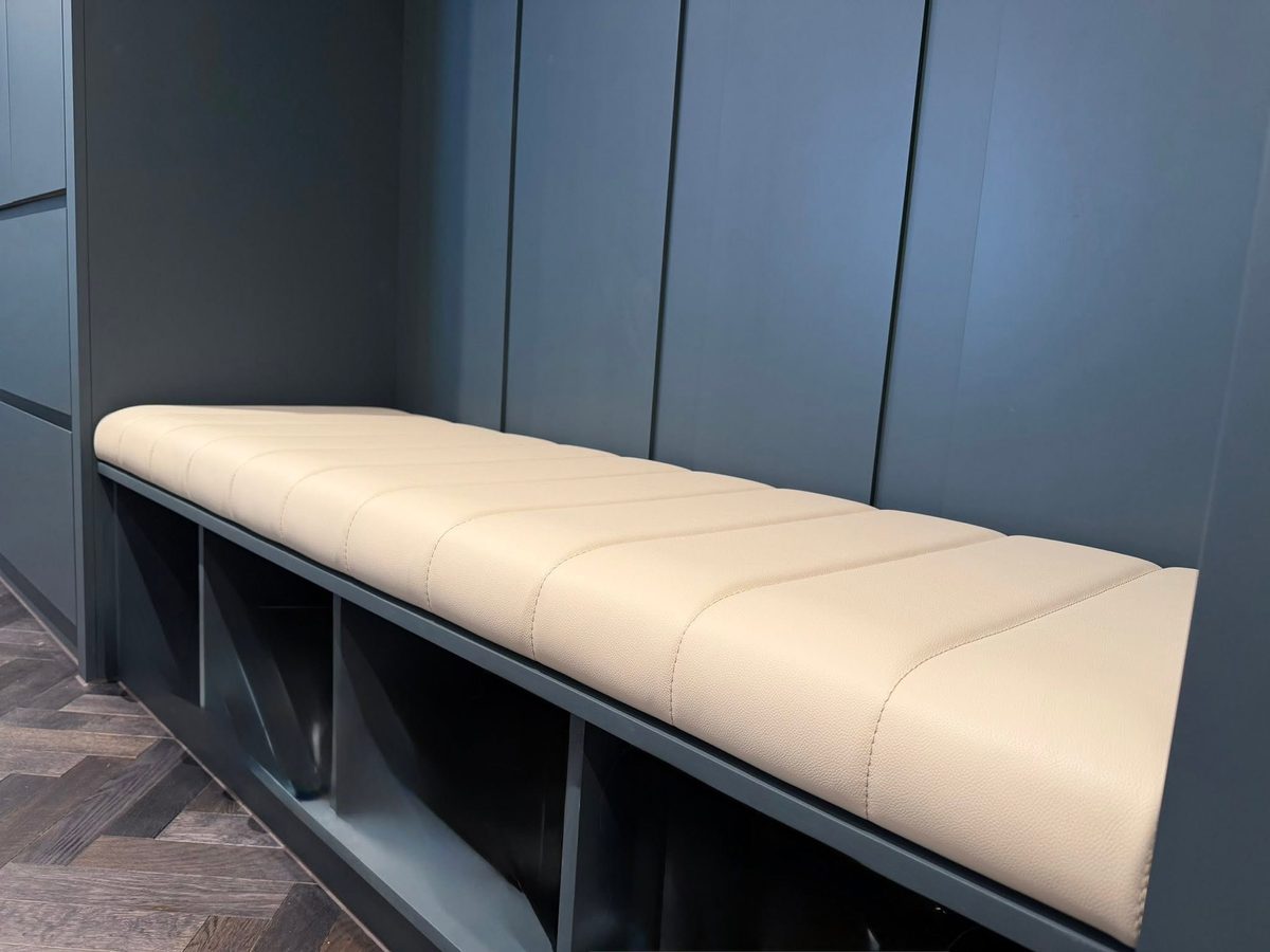Fluted cream leather bench cushion on dark blue joinery