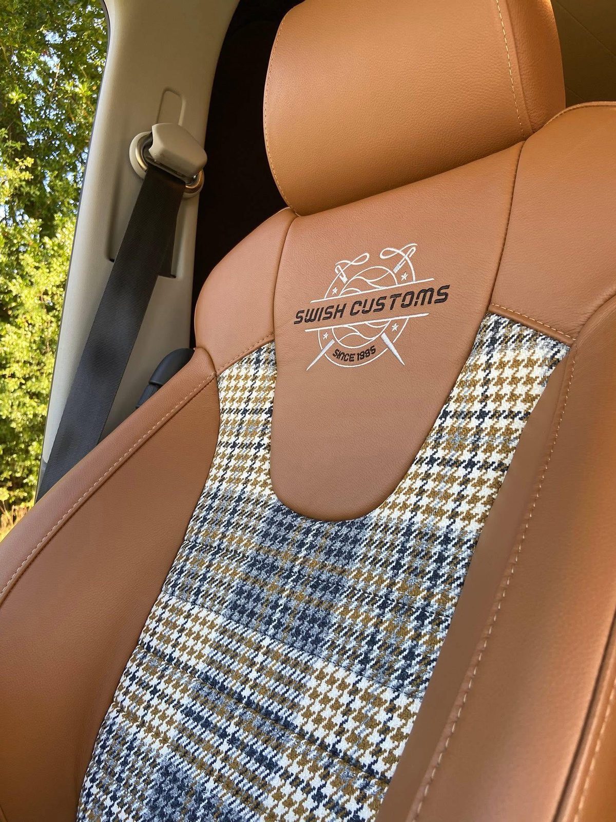 Embroidered Swish Customs logo on a seat