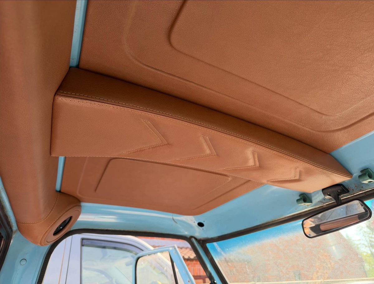Tan leather headlining with chevron stitching in a classic truck cab
